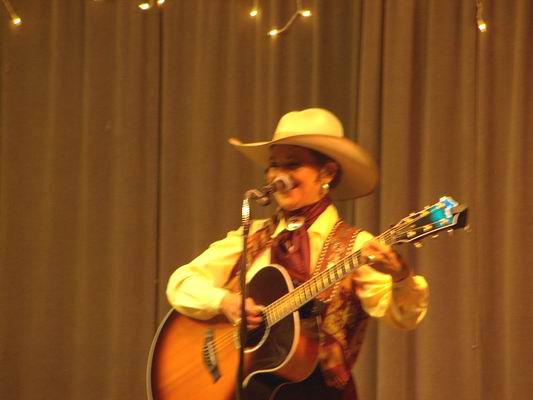 Belinda Gail close up on stage at the QIA