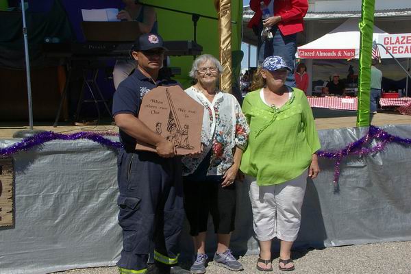 Jose from Quartzsite Fire & Rescue accepting plaque from Rainbow Acres