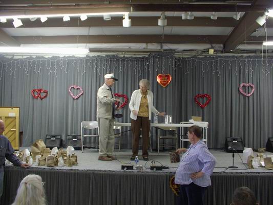 Iola and Dick getting ready to hand out the Vendor Gifts to the Volunteers