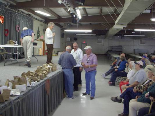 Various Volunteers coming up or awaiting their Gift from the Vendors!